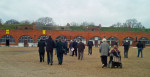 People walking across parade ground to fortified ramparts